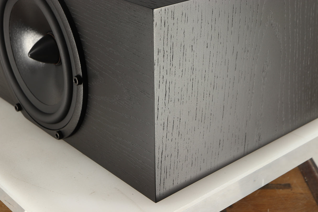 Front right corner of a used Spendor AC2 Centre Speaker in a black oak finish