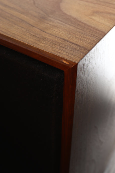 Close up view of an ex-demo Spendor Classic 100 Standmount Speaker in Walnut finish showing a small chip to the bottom front edge towards the left