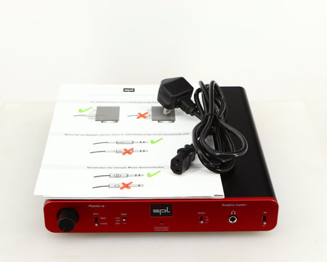 Top of a used SPL Phonitor SE Headphone Amplifier in a red finish showing Manual and Mains Cable