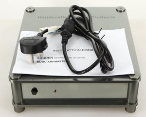 Top of a used Sugden Bijou Ampmaster Power Amplifier in a silver finish showing Manual and Mains Cable