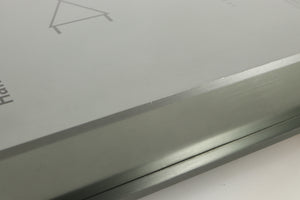 Close up of a used Sugden Bijou Ampmaster Power Amplifier in a silver finish showing some marking on left side