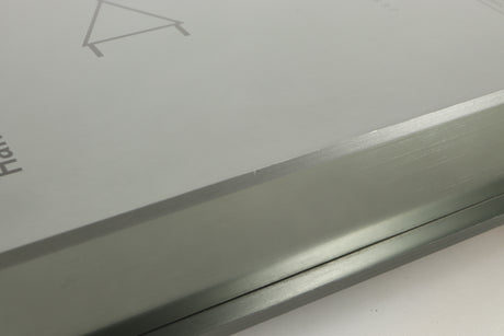 Close up of a used Sugden Bijou Ampmaster Power Amplifier in a silver finish showing some marking on left side