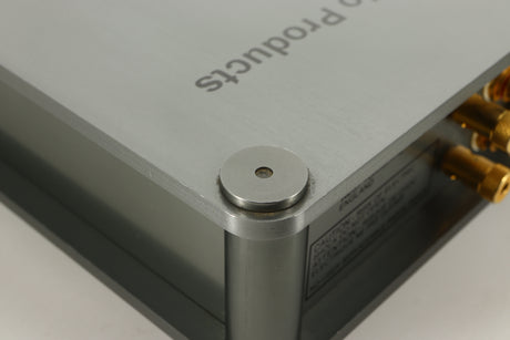 Close up of a used Sugden Bijou Ampmaster Power Amplifier in a silver finish showing some scratching and marks on rear right corner