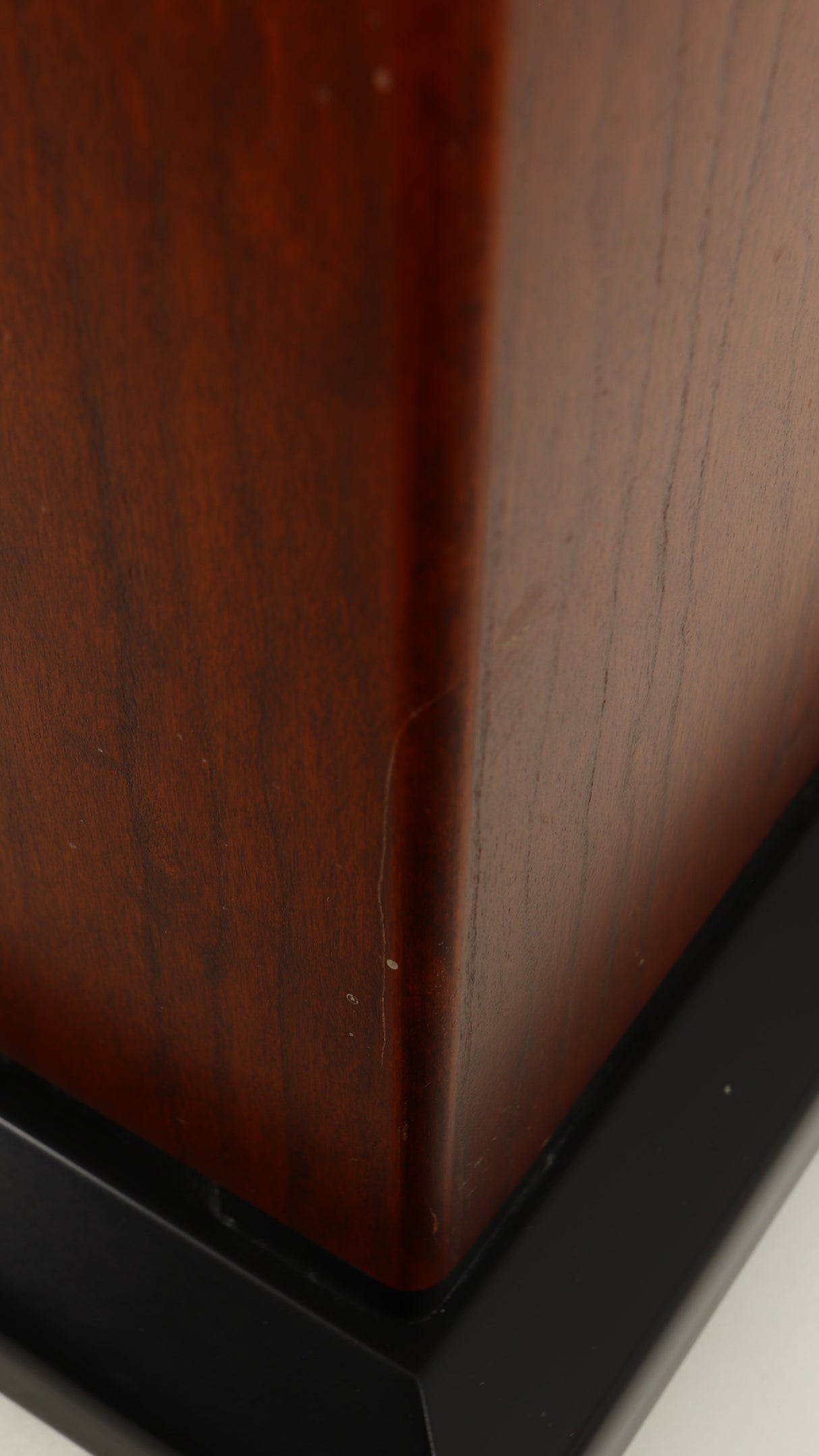 Close up of a used Sugden LS-21 Floorstanding Speaker in a dark cherry finish showing scratch on cabinet