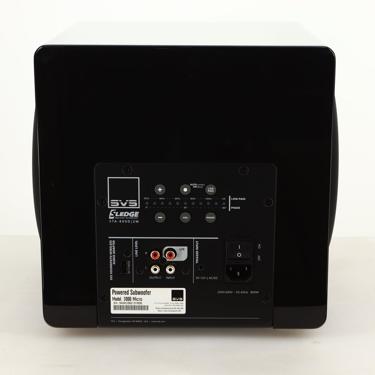 Rear view of a used SVS-3000 Micro Subwoofer W/ Wireless Kit in a piano black finish showing Mains Input, Phono Inputs, Phono Outputs and USB Input