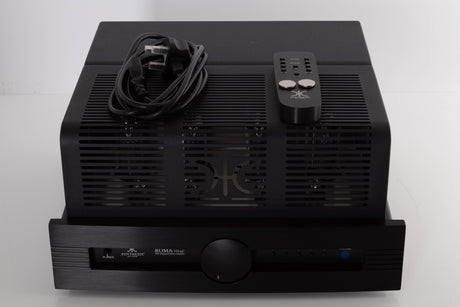 Top of a used Synthesis Roma 753AC Valve Integrated Amplifier in a Black finish showing Remote, Batteries and Mains Cable