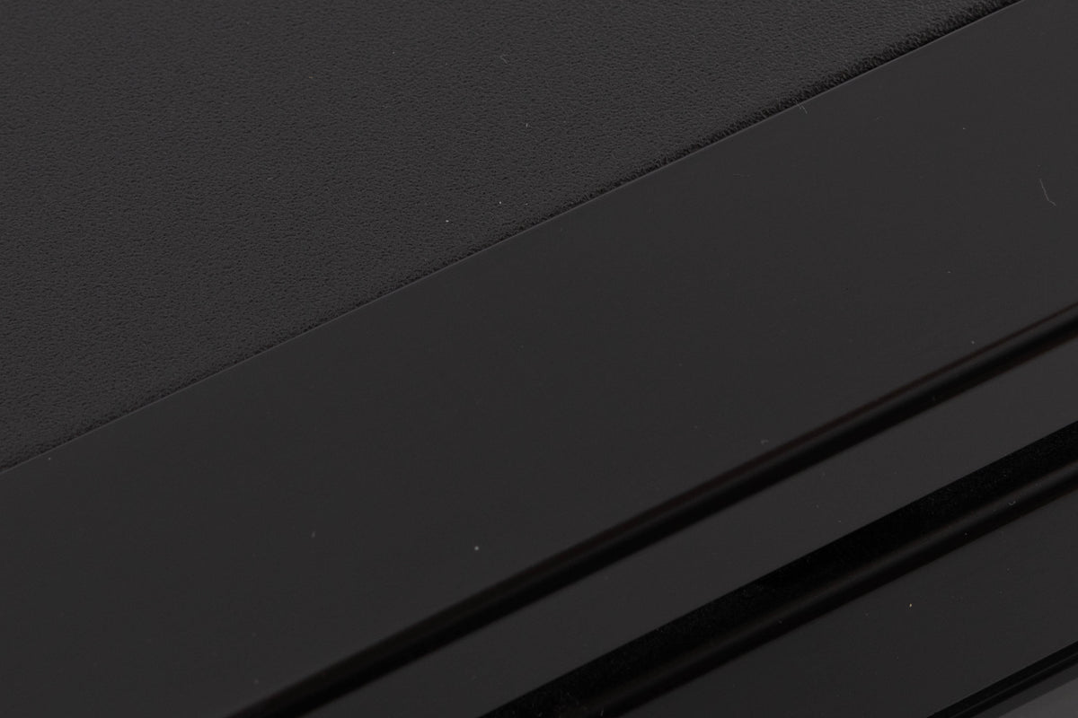 Close up of a used TEAC V-1050 Cassette Deck in a Black finish showing light scratching on front top edge