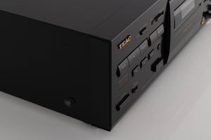 Front left corner of a used TEAC V-1050 Cassette Deck in a Black finish