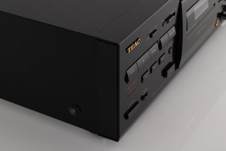 Front left corner of a used TEAC V-1050 Cassette Deck in a Black finish