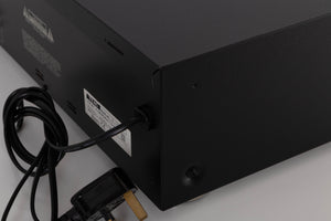 Rear left corner of a used TEAC V-1050 Cassette Deck in a Black finish