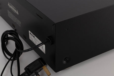 Rear left corner of a used TEAC V-1050 Cassette Deck in a Black finish