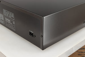 Rear left corner of a used Technics RS-B705 Cassette Deck in a black finish
