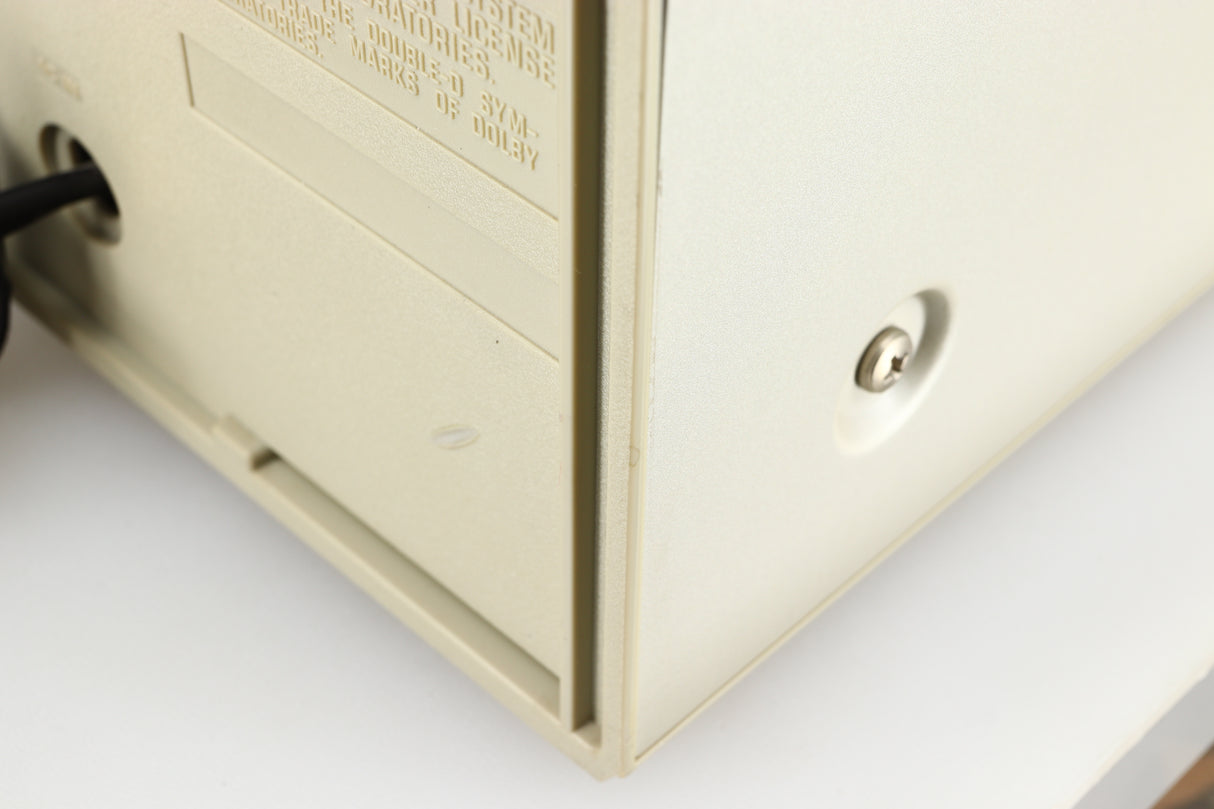 Close up of a used Technics RS-M225 Cassette Deck in a silver finish showing a scratch on the rear