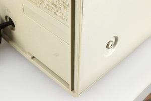 Close up of a used Technics RS-M225 Cassette Deck in a silver finish showing a scratch on the rear