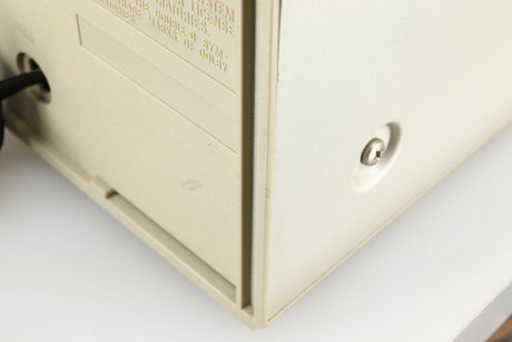 Close up of a used Technics RS-M225 Cassette Deck in a silver finish showing a scratch on the rear