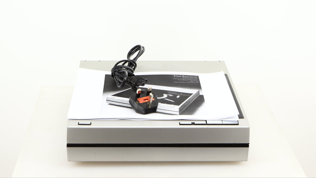 Top view of a used Technics SL-10 Turntable in a silver finish showing Manual and Power Cable