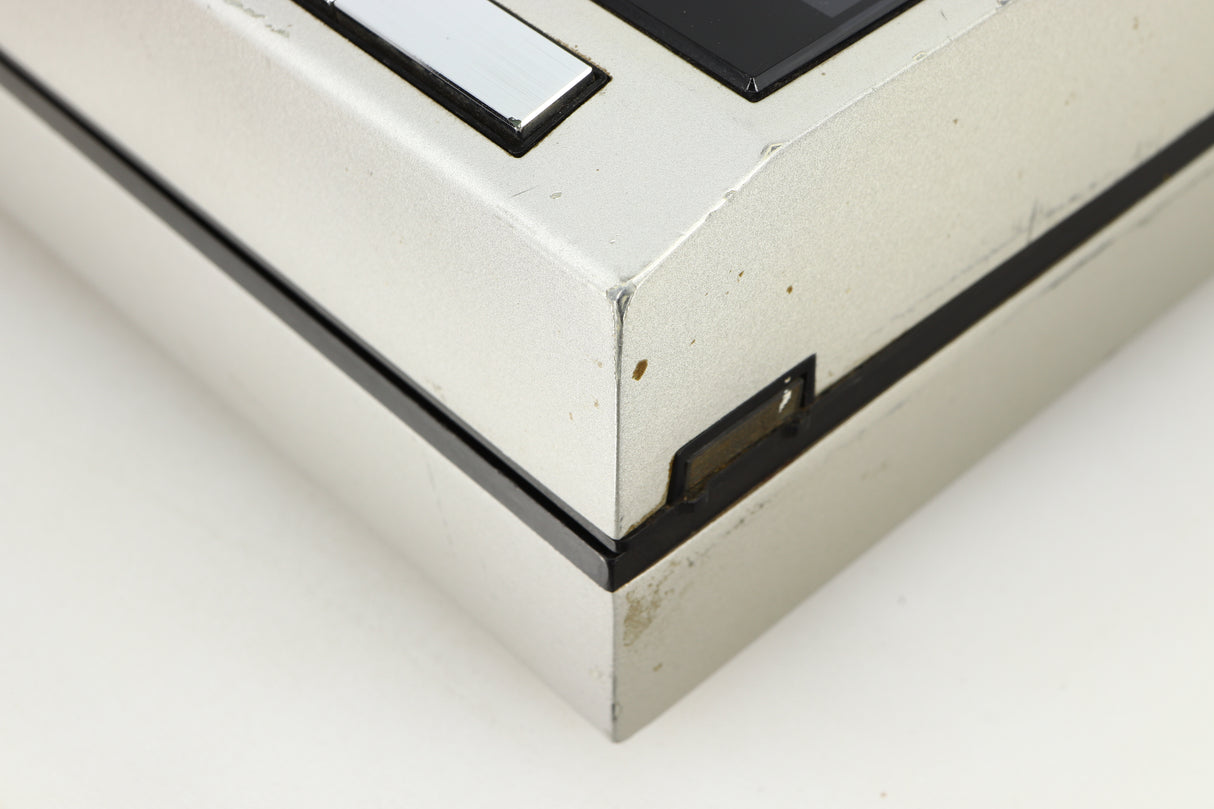 Close up of a used Technics SL-10 Turntable in a silver finish showing some damage