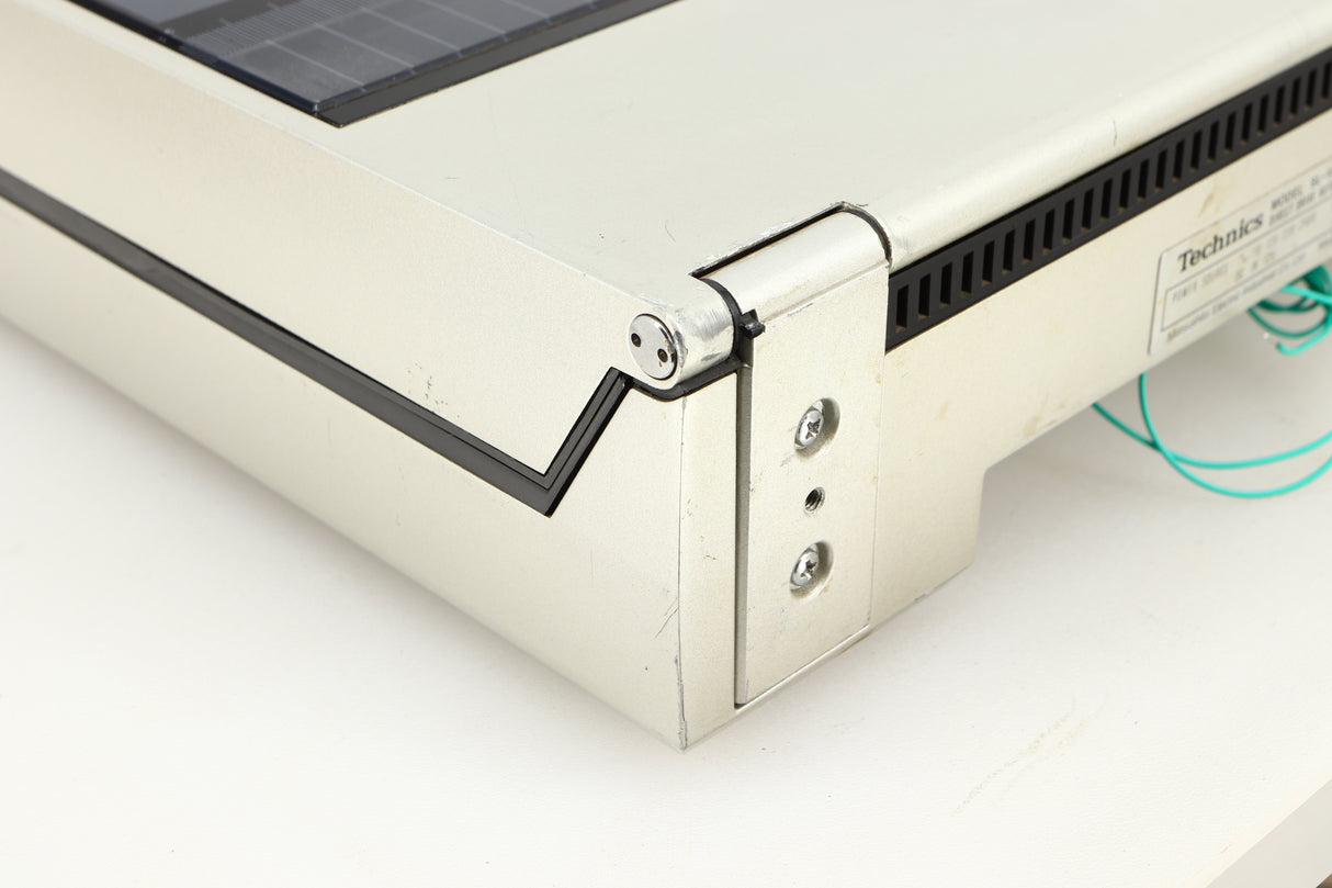 Rear right corner of a used Technics SL-10 Turntable in a silver finish
