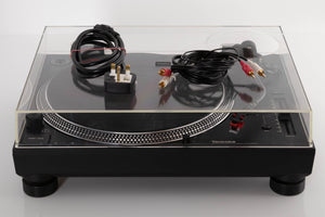 Front view of a used Technics SL-1210 MK7 Turntable with AT-40ML Cartridge with mains cable, and interconnects