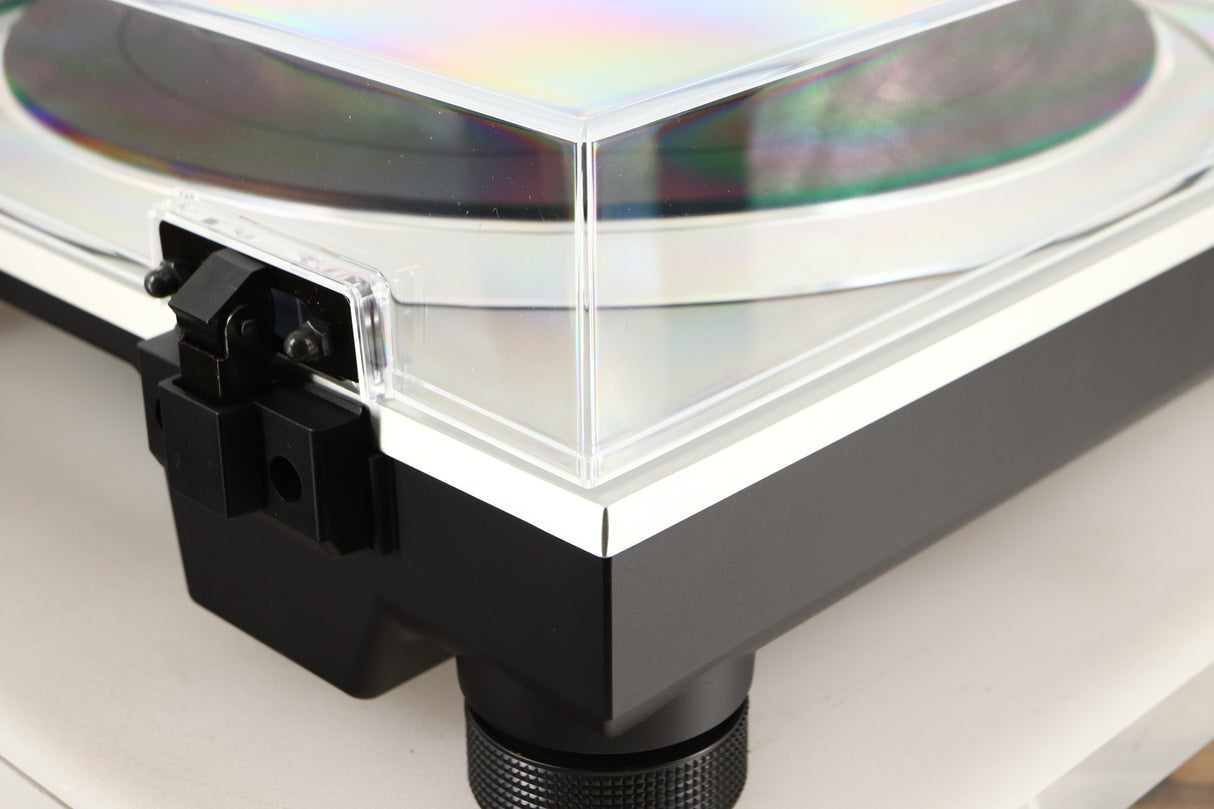 Rear left corner of a used Technics SL-1500C Turntable in a silver finish