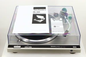 A used Technics SL-Q2 Direct Driver Turntable in Silver showing manual, and alignment protractor