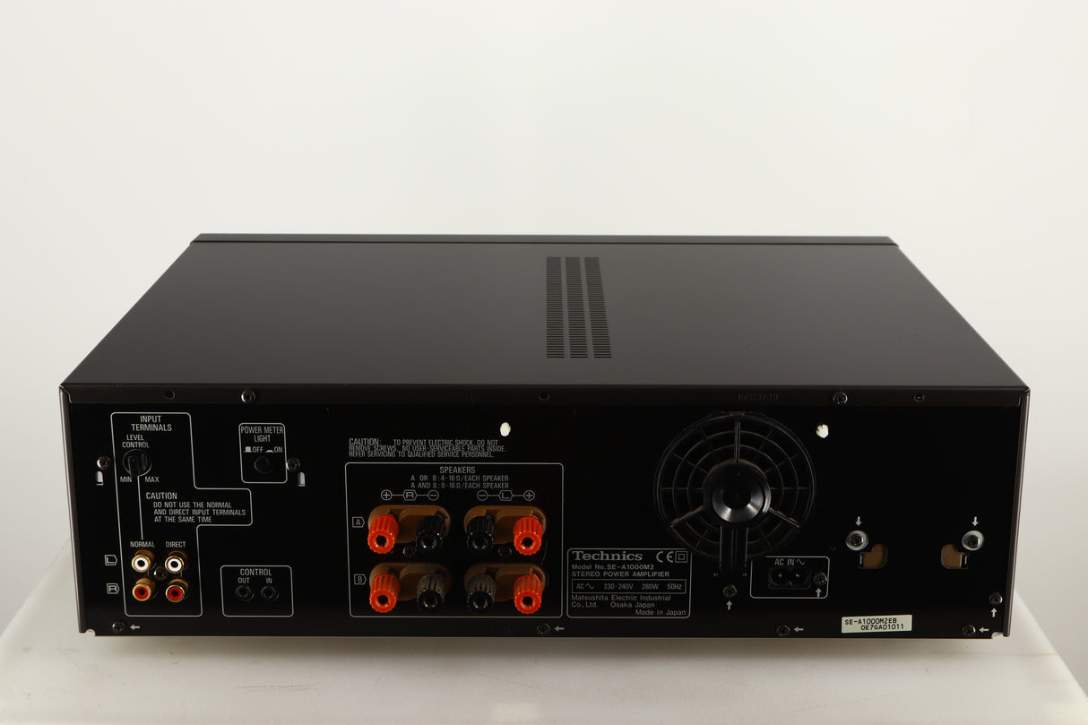 Rear view of a used Technics SE-A1000M2 Power Amplifier in a black finish showing Speaker Outputs, Phono Inputs and Power Input