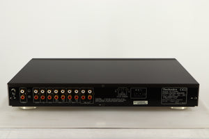 Rear view of a used Technics SU-C1000M2 Pre Amplifier in a black finish showing Phono Inputs, Phono Outputs and Power Cable
