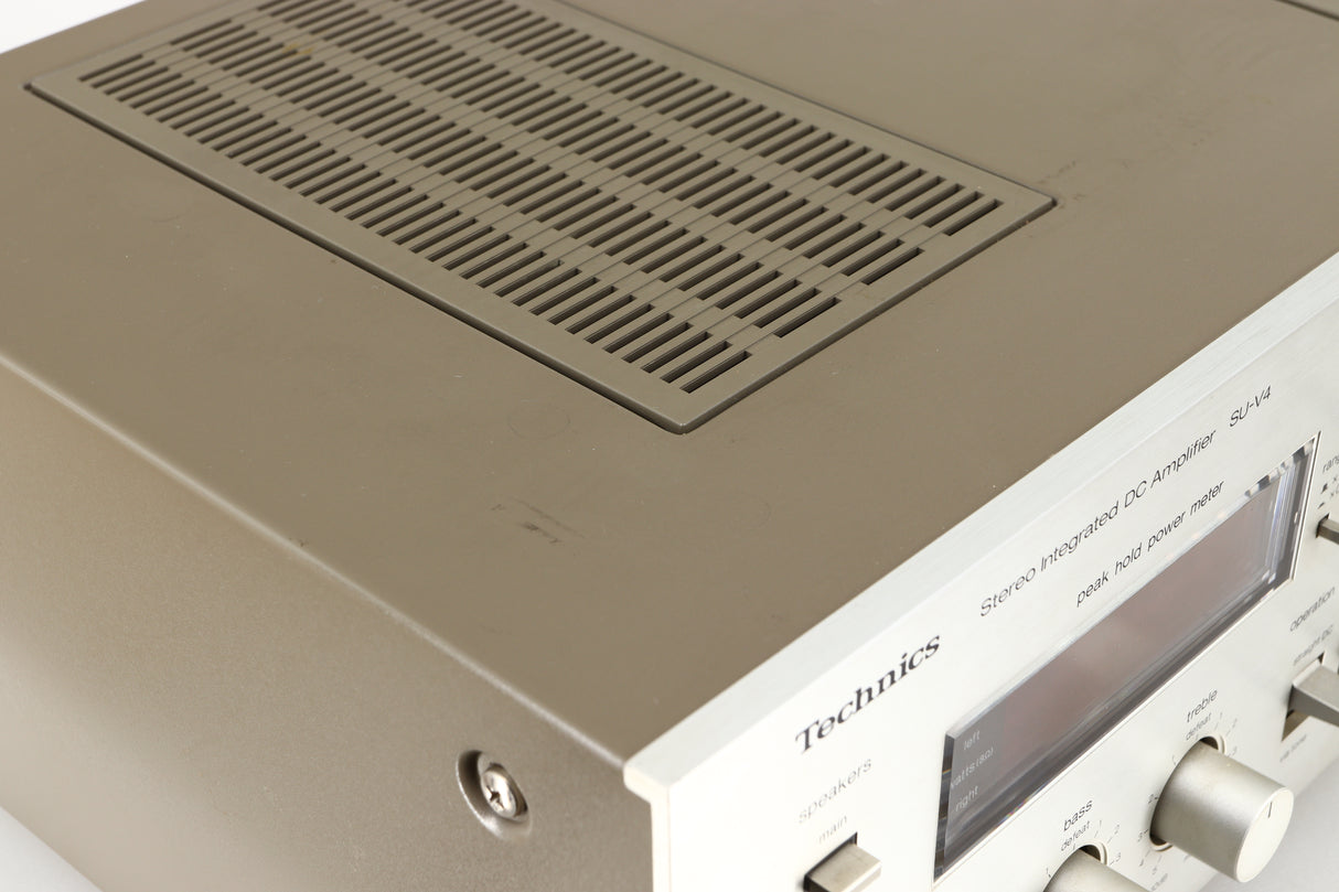 Close up of a used Technics SU-V4 Integrated Amplifier in a silver finish showing marks on top