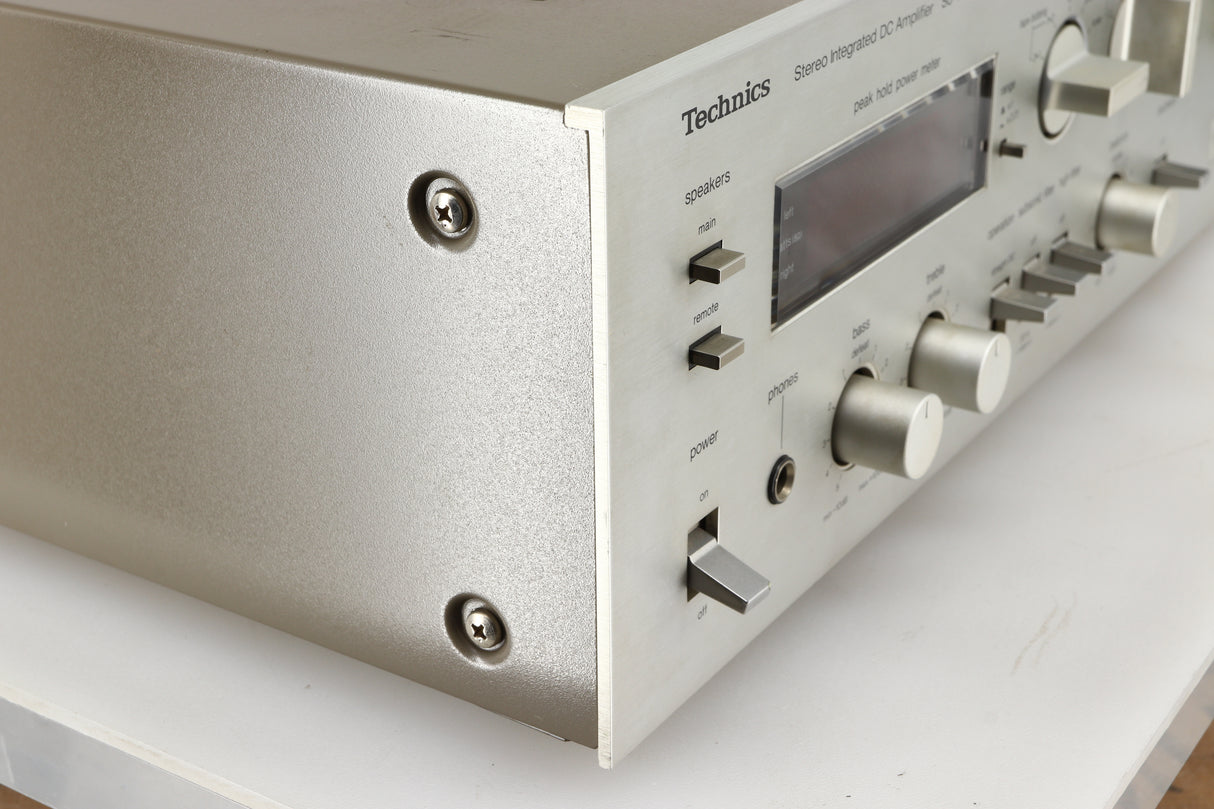 Front left corner of a used Technics SU-V4 Integrated Amplifier in a silver finish