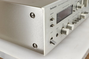 Front left corner of a used Technics SU-V4 Integrated Amplifier in a silver finish