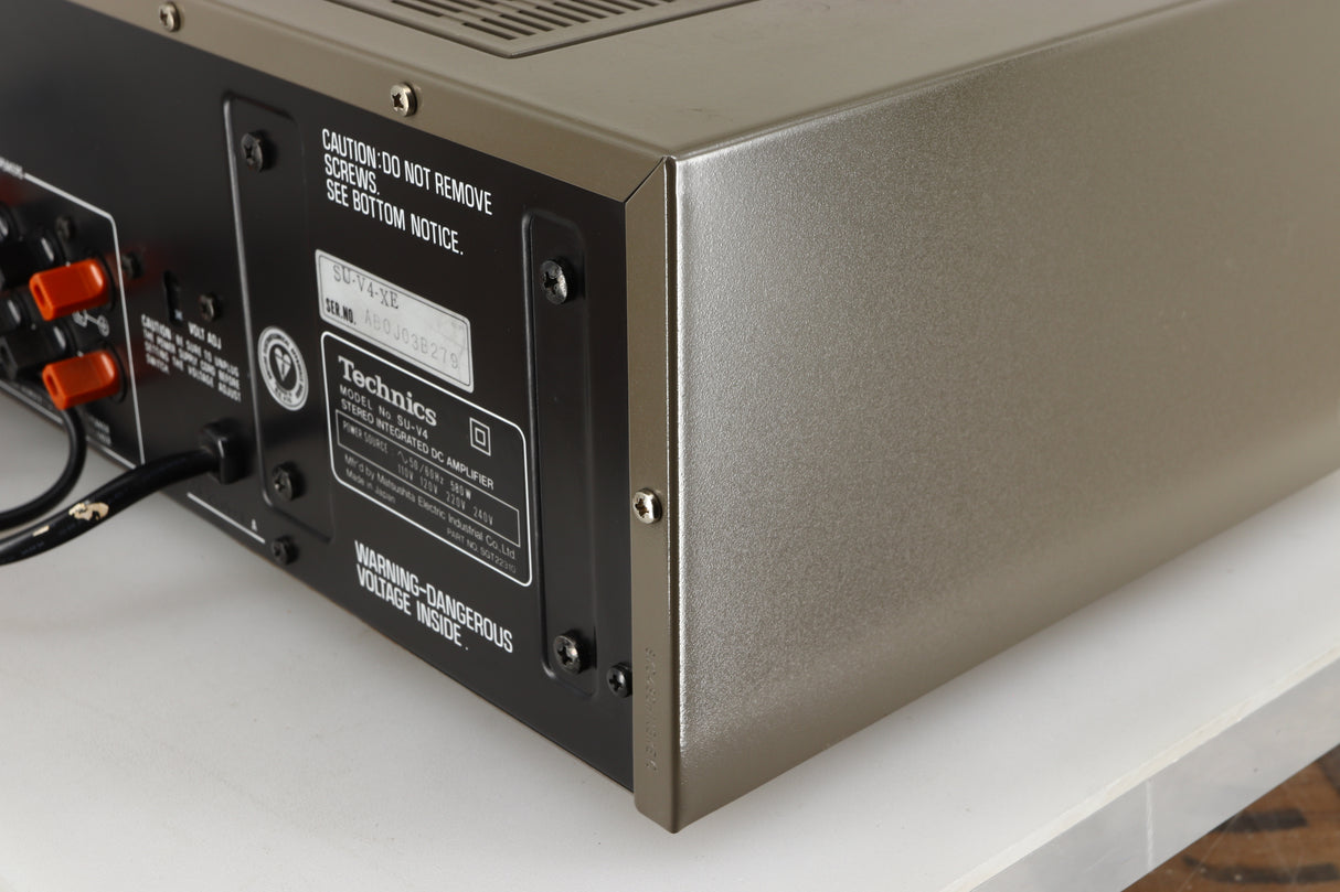 Rear left corner of a used Technics SU-V4 Integrated Amplifier in a silver finish