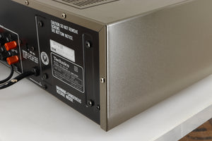 Rear left corner of a used Technics SU-V4 Integrated Amplifier in a silver finish