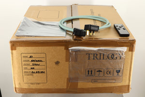 Box of a used Trilogy Audio H1 Valve Headphone Energiser in Natural finish with mains cable, manual, and remote