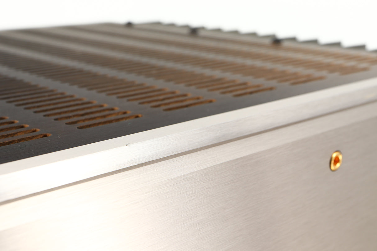 Close up of a used Usher R1.5 Power Amplifier in a silver finish showing small nick on fascia edge