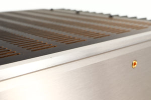 Close up of a used Usher R1.5 Power Amplifier in a silver finish showing small nick on fascia edge