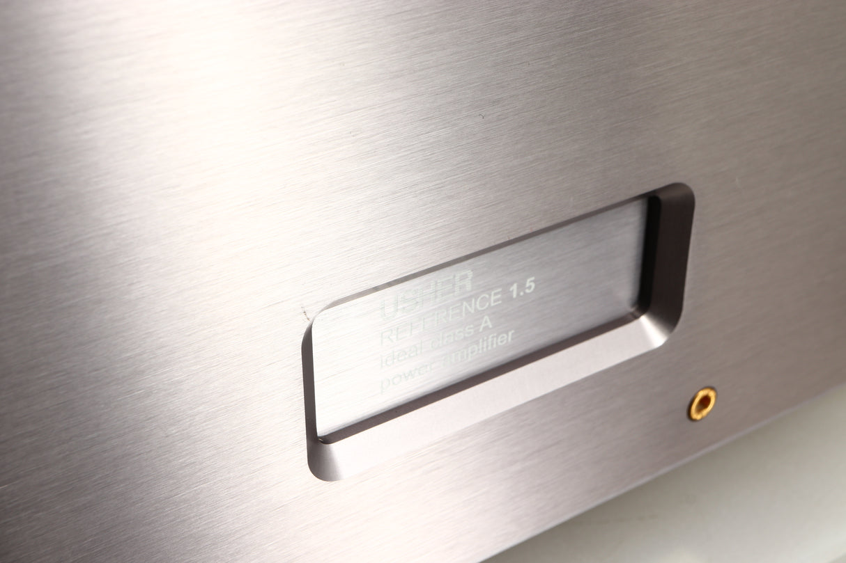 Close up of a used Usher R1.5 Power Amplifier in a silver finish showing minor scratch on fascia
