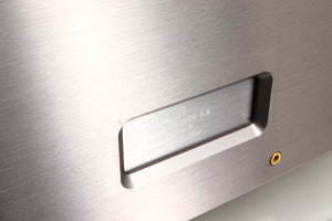 Close up of a used Usher R1.5 Power Amplifier in a silver finish showing minor scratch on fascia