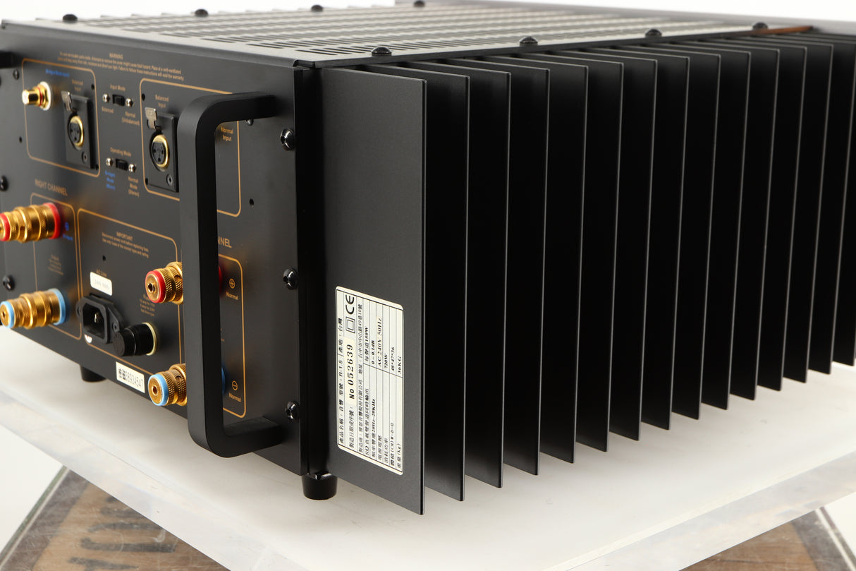 Rear left corner of a used Usher R1.5 Power Amplifier in a silver finish