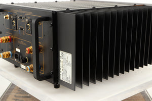 Rear left corner of a used Usher R1.5 Power Amplifier in a silver finish