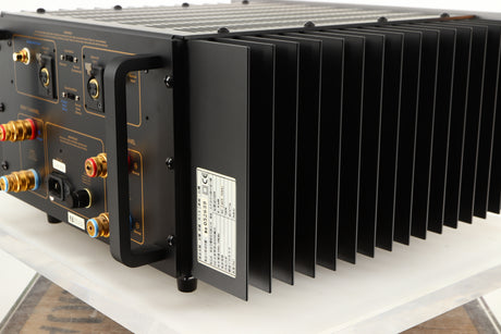 Rear left corner of a used Usher R1.5 Power Amplifier in a silver finish
