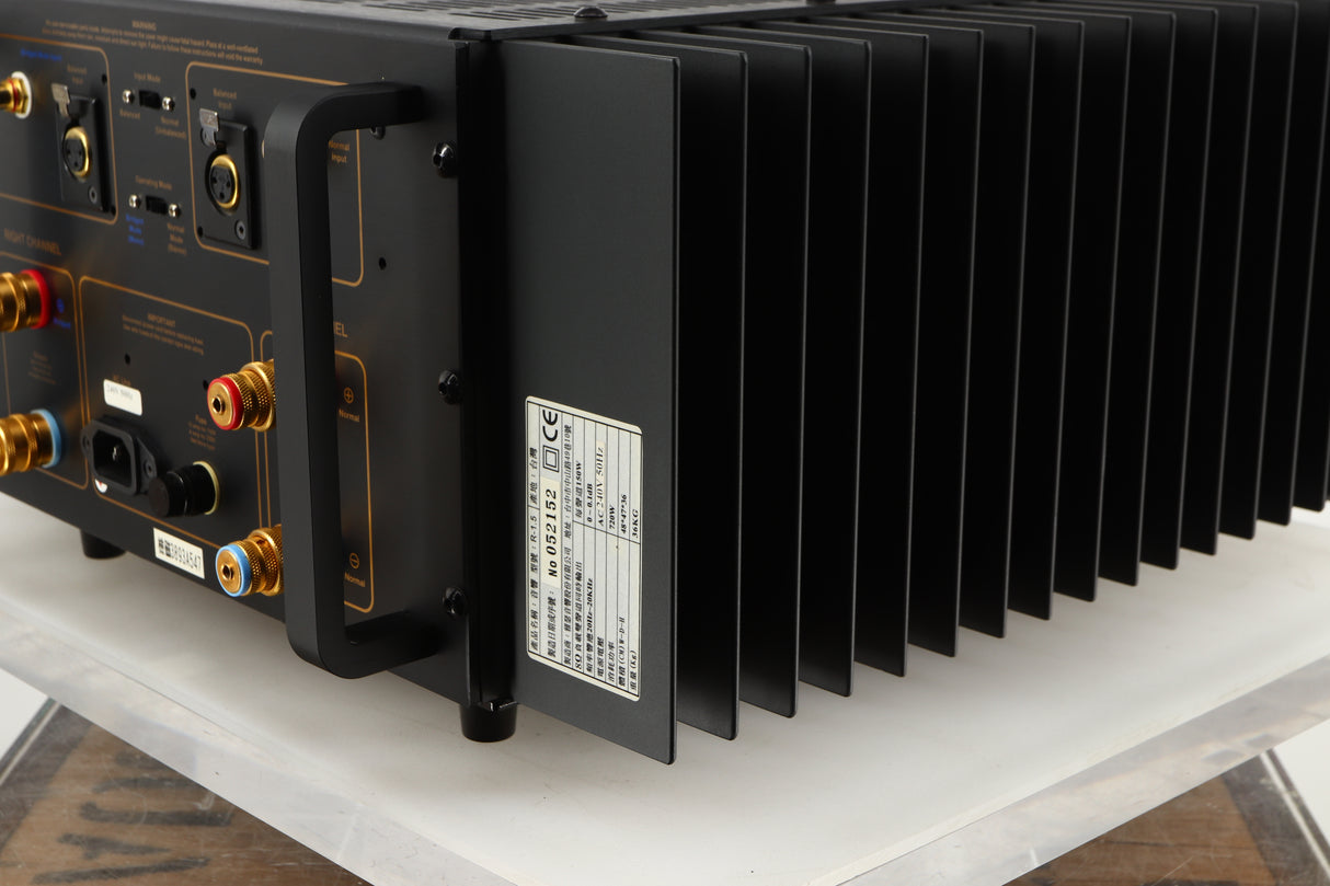 Rear left corner of a used Usher R1.5 Power Amplifier in a silver finish
