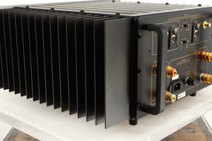 Rear right corner of a used Usher R1.5 Power Amplifier in a silver finish