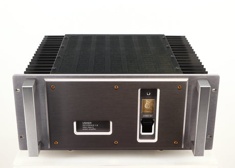 Top of a used Usher R1.5 Power Amplifier in a silver finish
