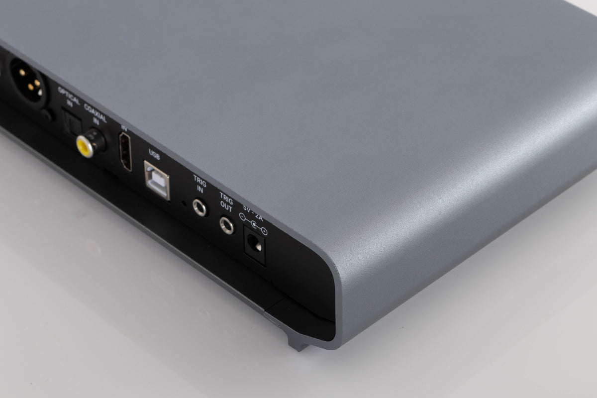 Rear left corner of a used Volumio Preciso Digital Analogue Converter in a Silver finish