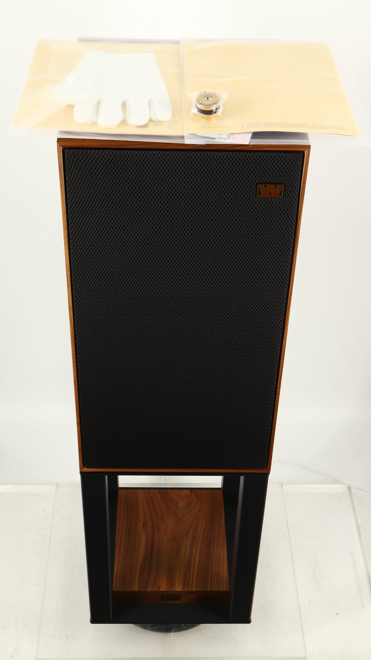 Top of a used Wharfedale Linton Standmount Speaker W/ Stand in a walnut finish showing 4x Gloves, 2x Manuals and 8x Floor Protectors