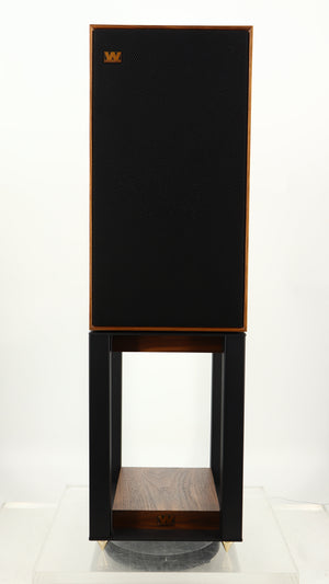 Front view of a used Wharfedale Linton Standmount Speaker W/ Stand in a walnut finish showing grille