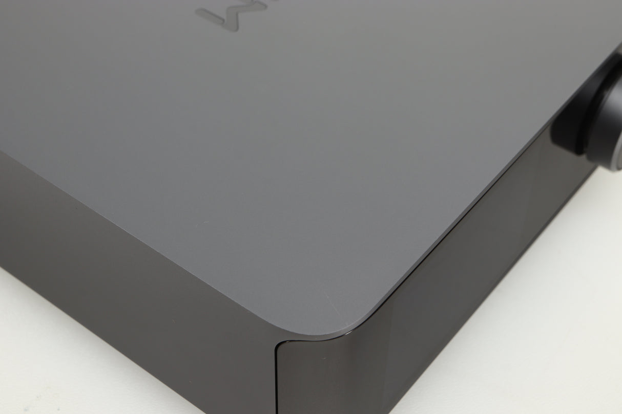 Close up of a used Wiim Amp Ultra Streaming Amplifier in a grey finish showing small scratch on top