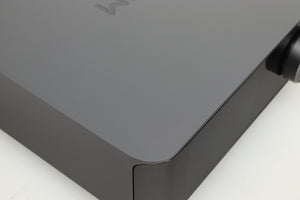 Close up of a used Wiim Amp Ultra Streaming Amplifier in a grey finish showing small scratch on top