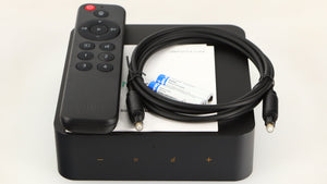 Top of a used Wiim Pro Plus Streamer in a black finish showing Manual, Remote, 2x Batteries and Optical Cable