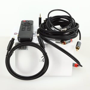 Box of a used Wiim Pro Plus Streamer showing a remote, manual, usb cable, interconnect cable, adaptor and optical cable